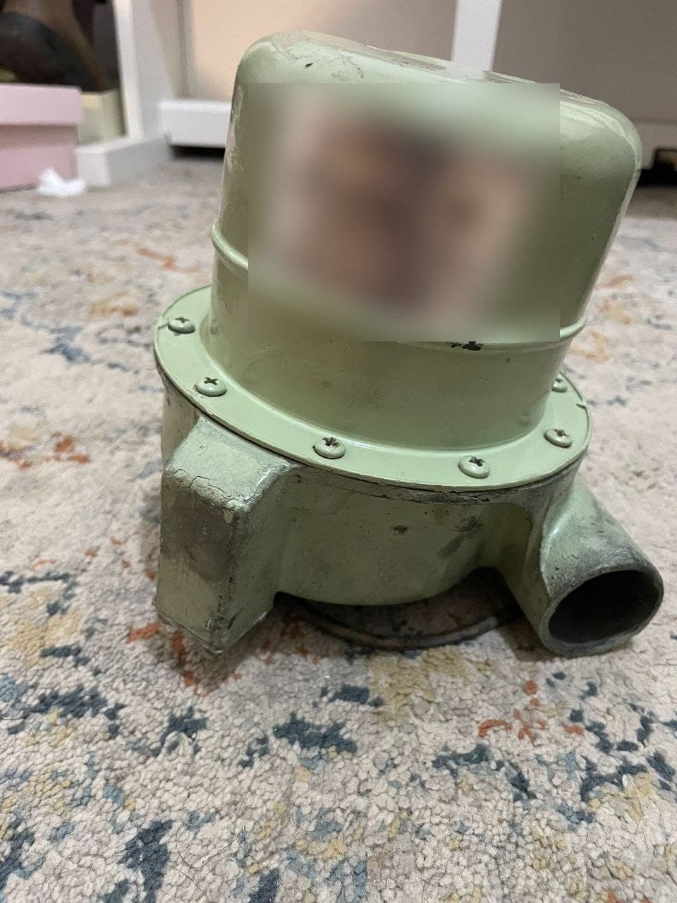 A refurbished air-filtration blower unit with its cast housing and outlet.
