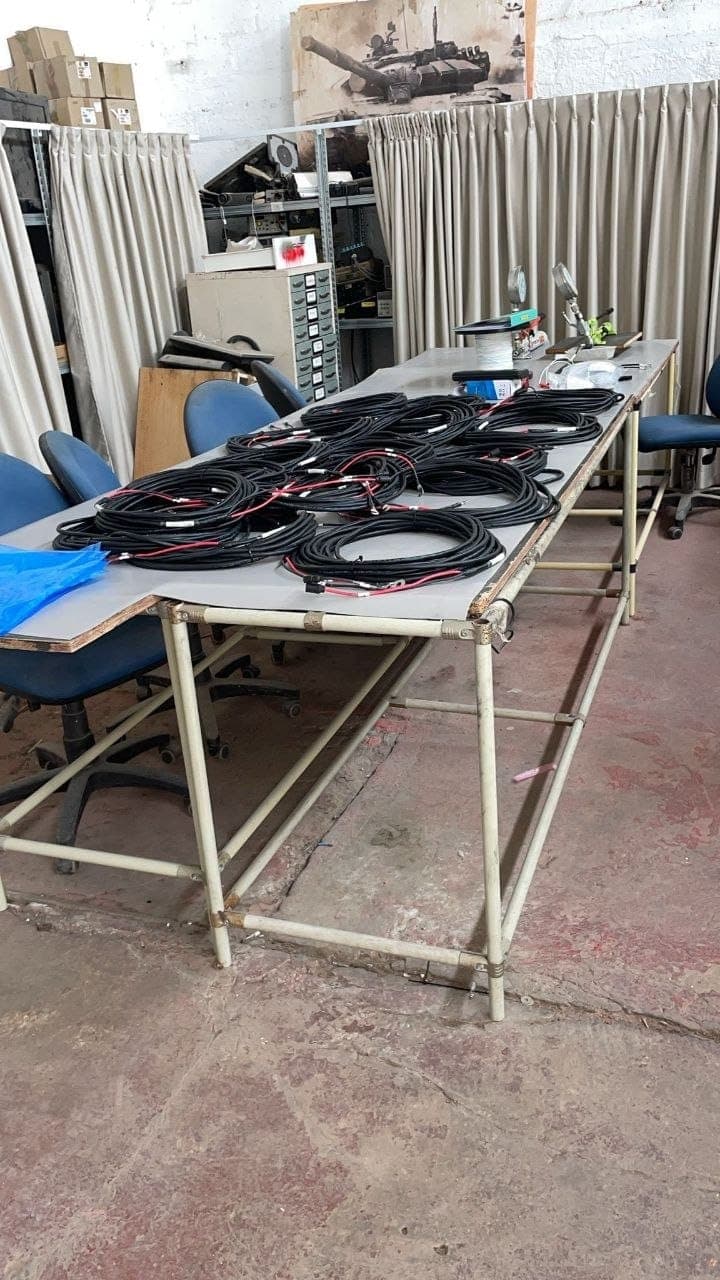 Coiled cable assemblies completed and set out on a workbench.